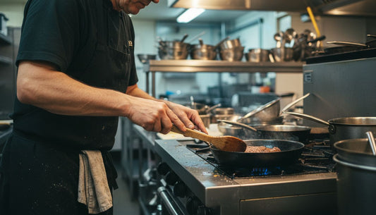 Chef searing steak in carbon steel pan
