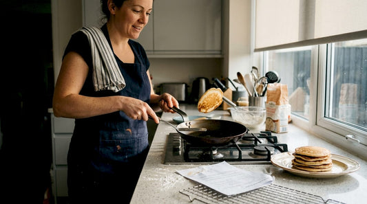 Home cook flipping pancake in carbon steel pan